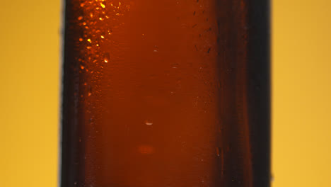Close-Up-Of-Condensation-Droplets-Running-Down-Side-Of-Revolving-Bottle-Of-Cold-Beer-Or-Soft-Drink-With-Copy-Space-1